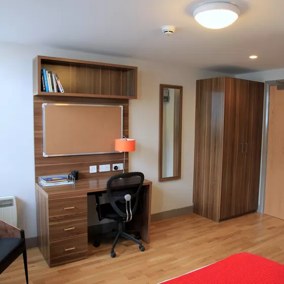 The study area with matching desk and wardrobe in a studio room at the Britannia student residence in Brighton.