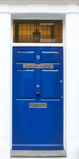 A close up photo of the blue door with the number 9 which is the front door of the English language centre in Chester.