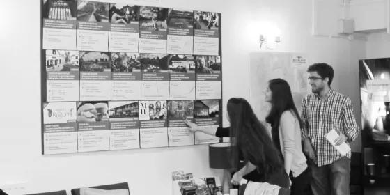 Students look at the range of excursions and activities available at the English language centre in Chester. The photograph is in black and white although it was taken quite recently.